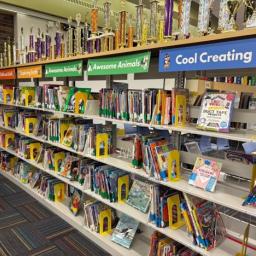 Library shelves with colorful signs