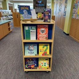 A selection of children's books on a shelf with a sign reading 'Introducing... Vox Books"