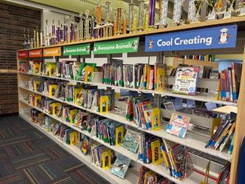 Library shelves with colorful signs