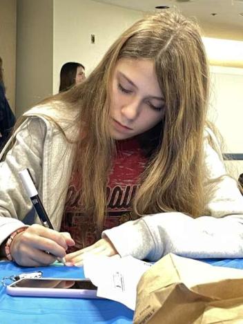 Teen hangout particpant makes a canvas magnet for her locker