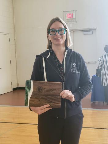 Director holding plaque