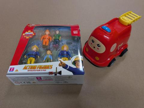 A set of 5 toy firefighter figurines and a firetruck